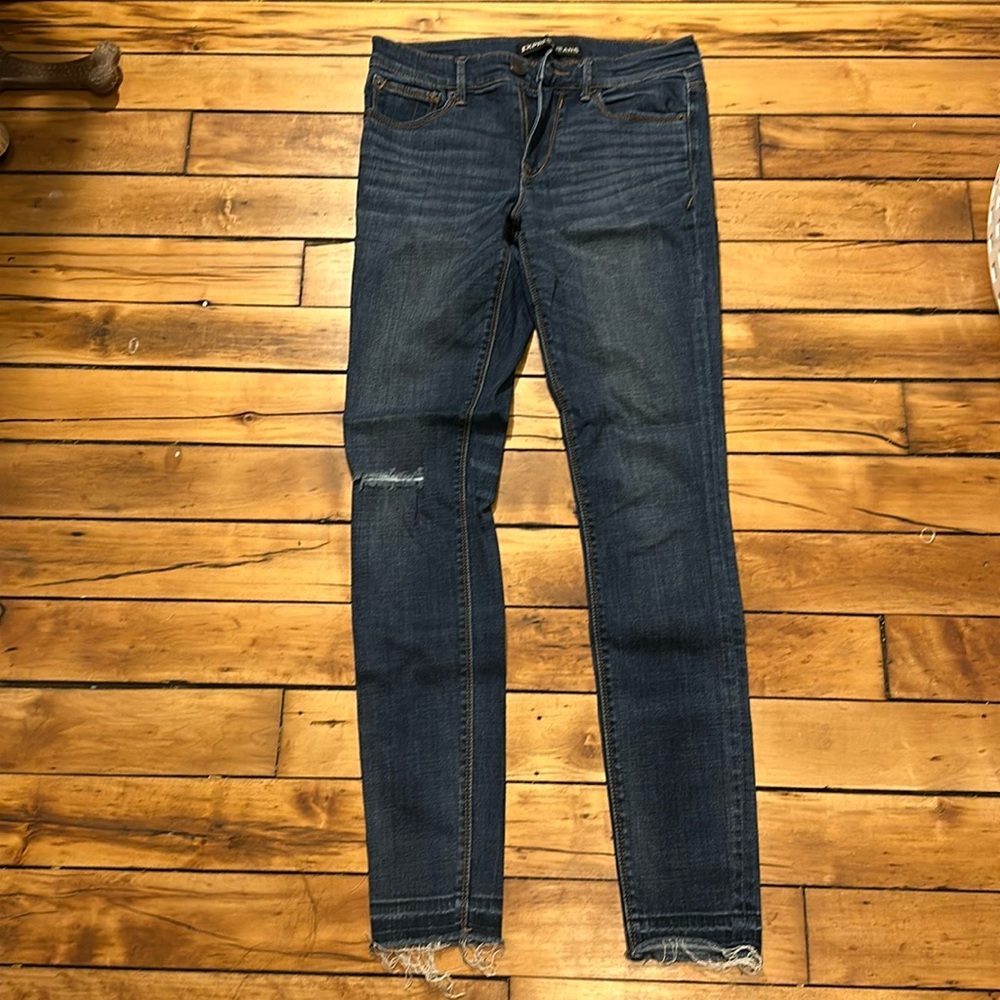 Mid rise dark wash jeans.